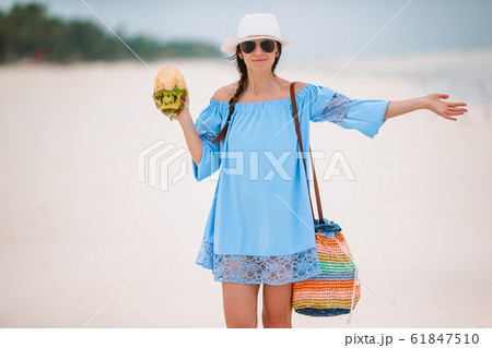 Young beautiful woman on white tropical beach. 61847510