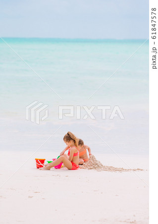 Adorable little girls during summer vacation on the beach Adorable little girls during summer vacation on the beach 61847578