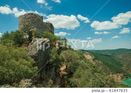 Castle on top of rocky cliff near the Tagus River at the Monfrague National Park Castle on top of rocky cliff near the Tagus River at the Monfrague National Park 61847635