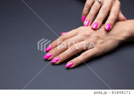 Stylish manicure pink on a black background Stylish manicure pink on a black background 61848171