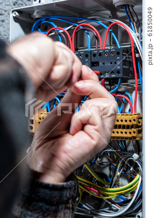 Electrician working on a residential electrical 61850049