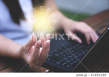 Young woman holding light bulb. Innovative idea concept 61850189