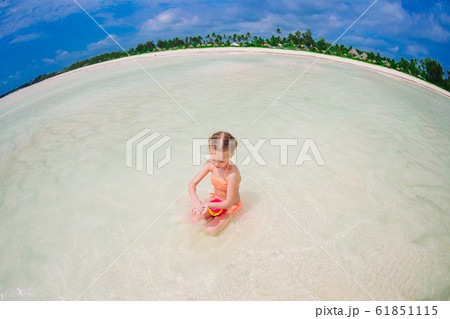 Cute little girl at beach during caribbean vacation 61851115