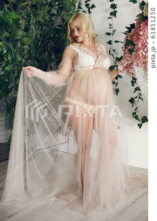 Beautiful pregnant woman with big belly in a studio 61851250