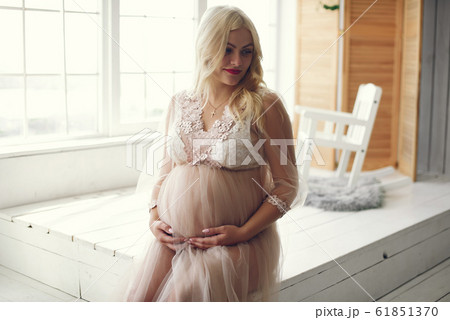 Beautiful pregnant woman with big belly in a studio Beautiful pregnant woman with big belly in a studio 61851370