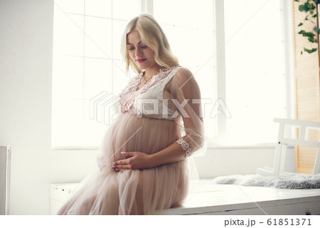Beautiful pregnant woman with big belly in a studio 61851371