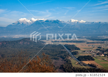 winter Alps mountains over valley forest highway winter Alps mountains over valley forest highway 61852324