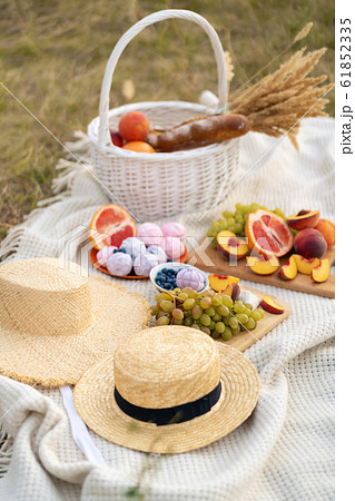 Stylish summer picnic on a white blanket. Stylish summer picnic on a white blanket. 61852335