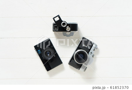 Vintage cameras on the white wooden background. Concept of old technology. Photo with place for text. Sweden. Scandinavia. Top view Vintage cameras on the white wooden background. Concept of old technology. Photo with place for text. Sweden. Scandinavia. Top view 61852370