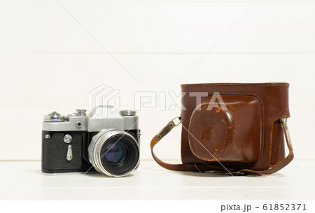Vintage camera on the white wooden background. Concept of old technology. Photo with place for text. Sweden. Vintage camera on the white wooden background. Concept of old technology. Photo with place for text. Sweden. 61852371