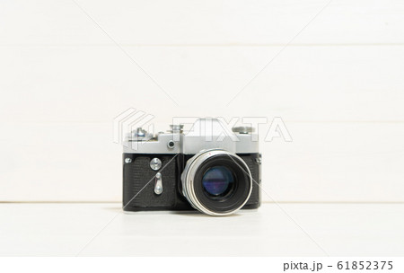 Vintage camera on the white wooden background. Concept of old technology. Photo with place for text. Sweden. 61852375