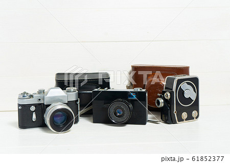 Vintage cameras on the white wooden background. Concept of old technology. Photo with place for text. Sweden. Vintage cameras on the white wooden background. Concept of old technology. Photo with place for text. Sweden. 61852377