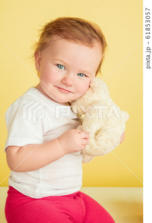 Caucasian little girl, children isolated on yellow studio background 61853057