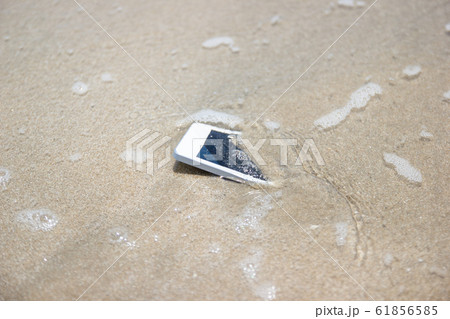 White Mobile phone floated to the sea at the beach. White Mobile phone floated to the sea at the beach. 61856585
