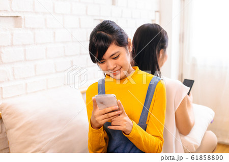 Everyone on their phones at home. Mother and daughter into phone addiction. 61858890