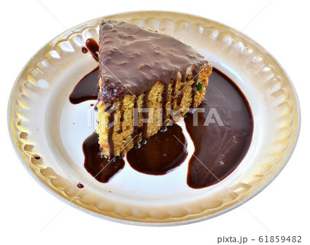 Sponge cake with chocolate icing on a plate Sponge cake with chocolate icing on a plate 61859482