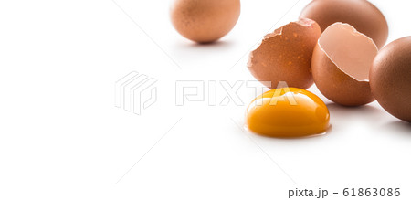 Chicken eggs and broken egg with yolk isolated on 61863086