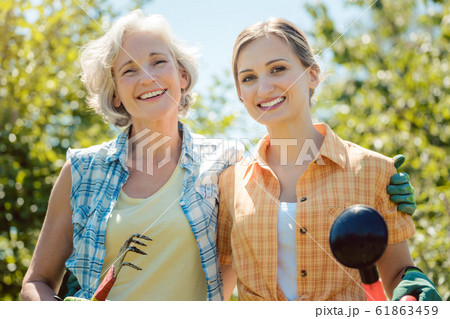 Woman gardening together in summer 61863459
