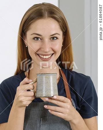 Happy beautiful woman drinking coffee Happy beautiful woman drinking coffee 61864087