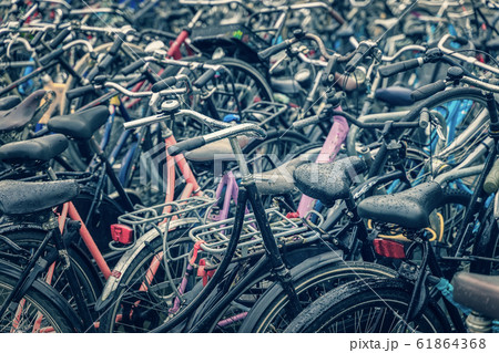 Bicycle parking with many bicycles, rayny day in Amsterdam Bicycle parking with many bicycles, rayny day in Amsterdam 61864368