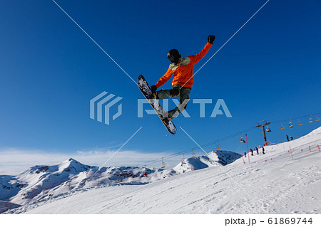 Snowboarder does the jumping trick. Livigno, Italy Snowboarder does the jumping trick. Livigno, Italy 61869744