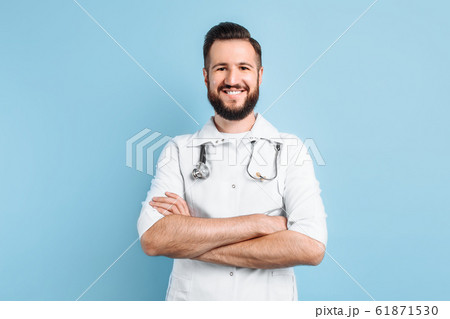 A positive male doctor looks at the camera with A positive male doctor looks at the camera with 61871530