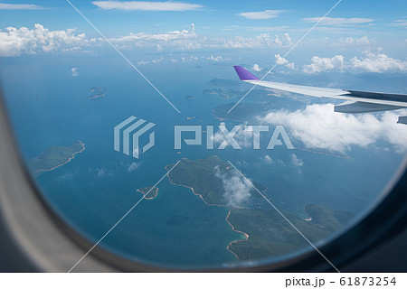 Wing of airplane flying above Hong Kong city 61873254