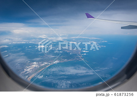 Wing of airplane flying above Hong Kong city 61873256