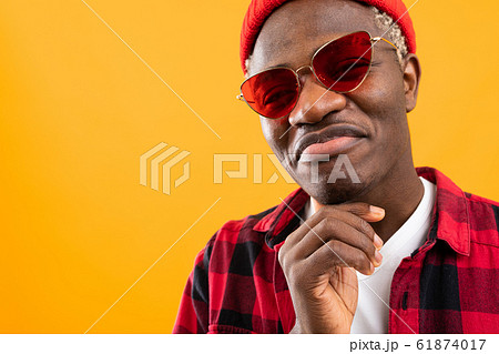 stylish black american man in red retro glasses on yellow background with copy space stylish black american man in red retro glasses on yellow background with copy space 61874017