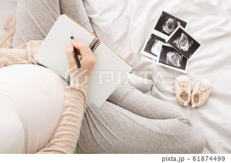 Pregnant woman writing to-do-list, top view, free space 61874499