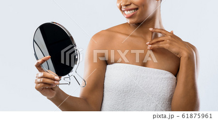Cropped of african woman in towel looking at mirror 61875961