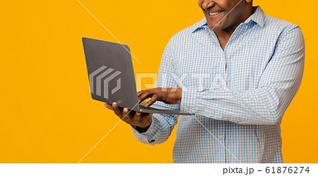 Mature african man typing on laptop, panorama 61876274