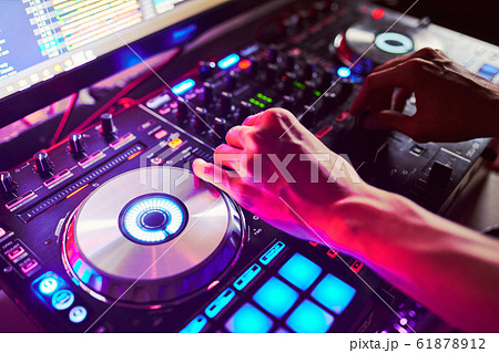 Dj mixes the track in the nightclub at a party Dj mixes the track in the nightclub at a party 61878912