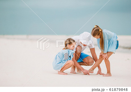 Father and kids enjoying beach summer vacation Father and kids enjoying beach summer vacation 61879848