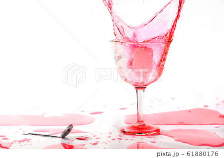 Red alcohol cocktail drink splash on white background. Red alcohol cocktail drink splash on white background. 61880176