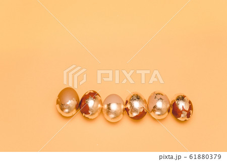 Easter greeting card. Golden eggs lined up in a Easter greeting card. Golden eggs lined up in a 61880379