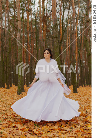 Happy beautiful bride in the autumn in the forest. 61880478
