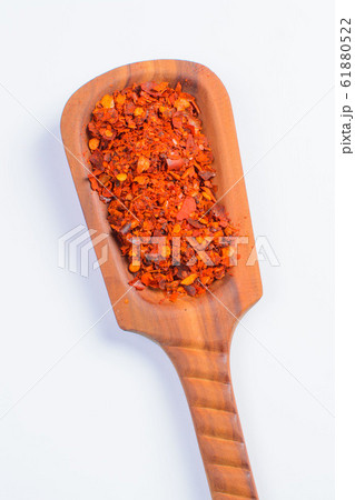 wooden shovel with seeds of red pepper on a white background wooden shovel with seeds of red pepper on a white background 61880522