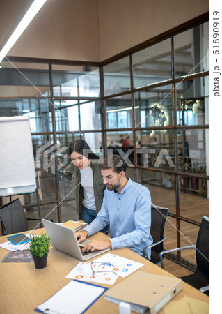 Young manager and his assistant working together in the office 61890919