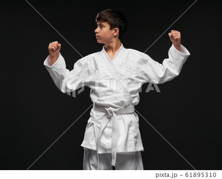 sport concept - a teenager dressed in martial arts 61895310