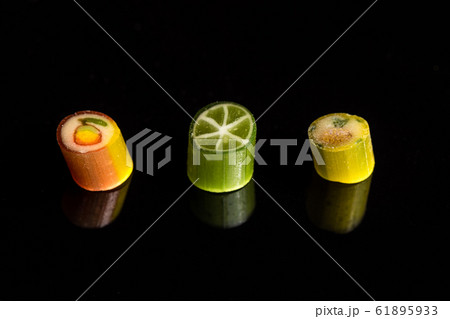 Natural handmade caramel candies with fruit pattern. Macro Natural handmade caramel candies with fruit pattern. Macro 61895933