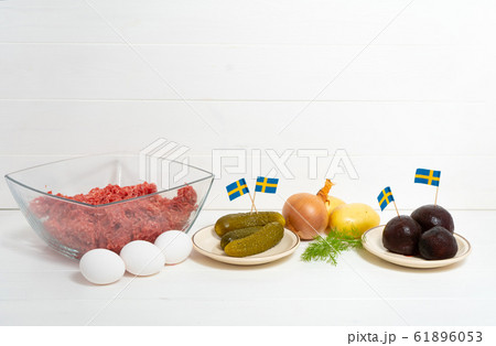 Ingredients for a traditional Swedish dish beef Lindstrom. Freshly minced beef, boiled potato, white chopped onion, pickles, pickled red beets, eggs. Swedish cuisine. Scandinavian Ingredients for a traditional Swedish dish beef Lindstrom. Freshly minced beef, boiled potato, white chopped onion, pickles, pickled red beets, eggs. Swedish cuisine. Scandinavian 61896053