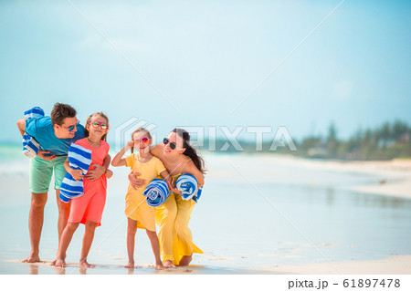 Young family of four on beach vacation 61897478