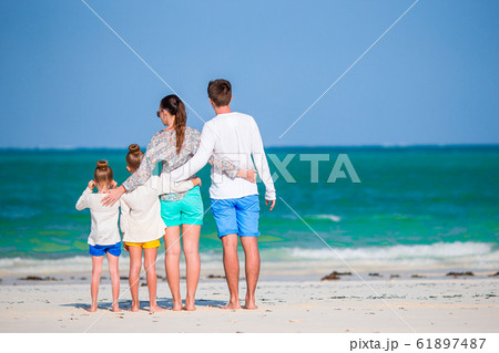 Happy beautiful family of four on the beach Happy beautiful family of four on the beach 61897487
