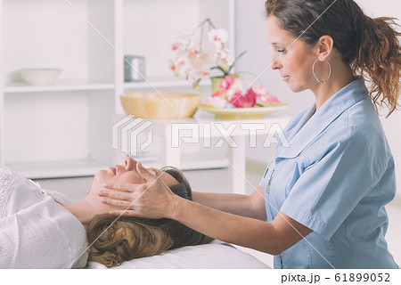 Professional Reiki healer doing reiki Professional Reiki healer doing reiki 61899052
