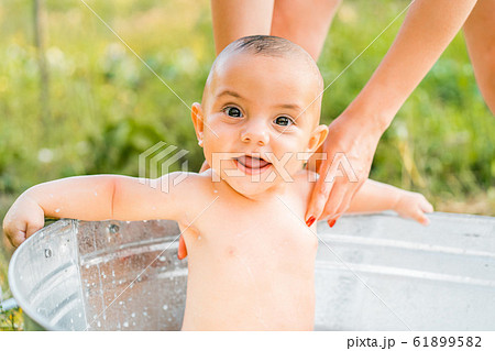 Cute little smiling baby boy portrait in milk bath. Healthy lifestyle. child in summer garden, nature concept. Cute little smiling baby boy portrait in milk bath. Healthy lifestyle. child in summer garden, nature concept. 61899582