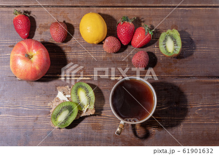Fruits,  Cup of tea   and sandwich on boards 61901632