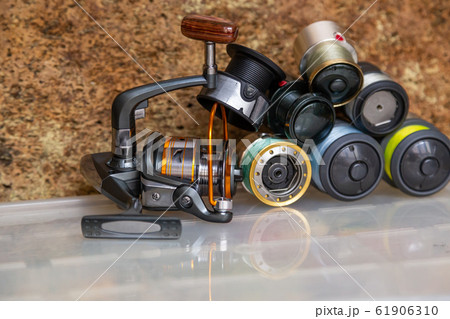 Different fishing tackles, lines and reel on 61906310