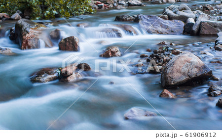 Wild nature concept. Raging mountain river running 61906912