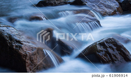 Nature scene of rough, fast flowing river hitting Nature scene of rough, fast flowing river hitting 61906914